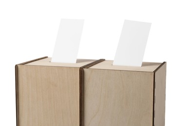 Wooden ballot boxes with votes isolated on white