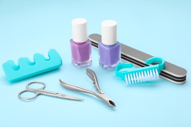 Photo of Set of pedicure tools on light blue background