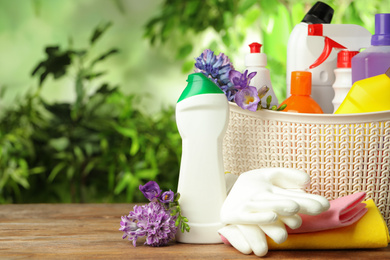 Photo of Spring flowers and cleaning supplies on wooden table