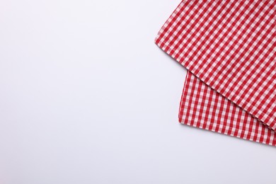 Photo of Red checkered tablecloth on white background, top view
