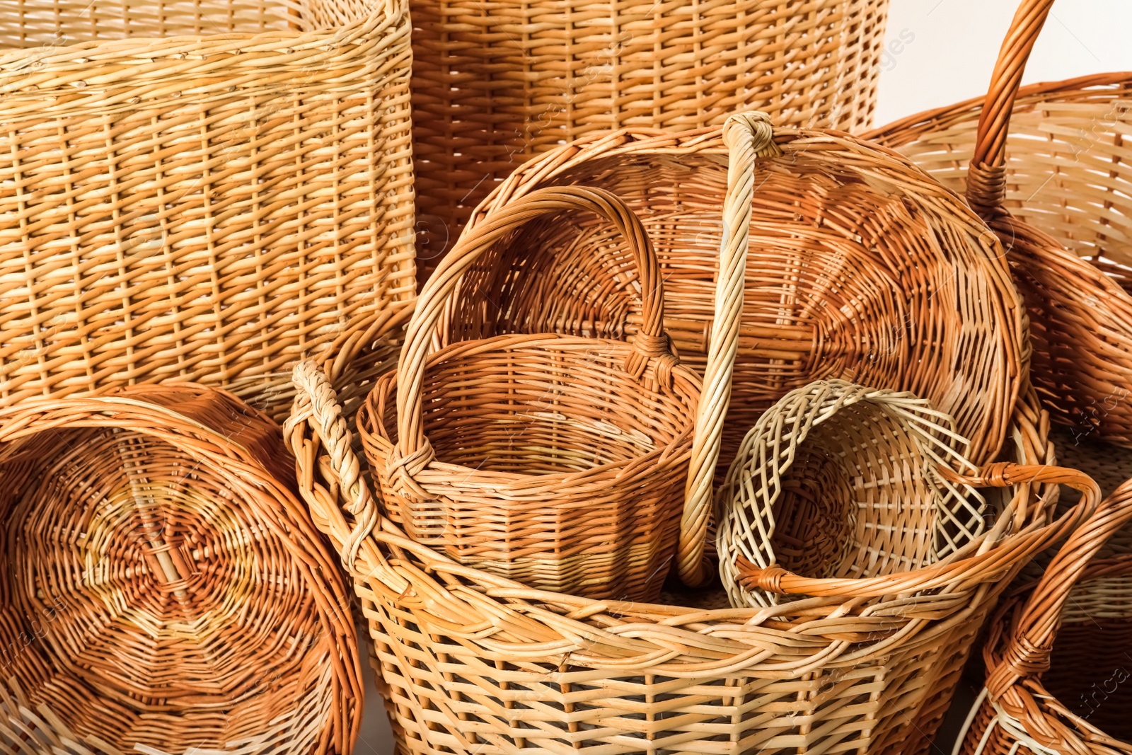 Photo of Many different wicker baskets made of natural material as background