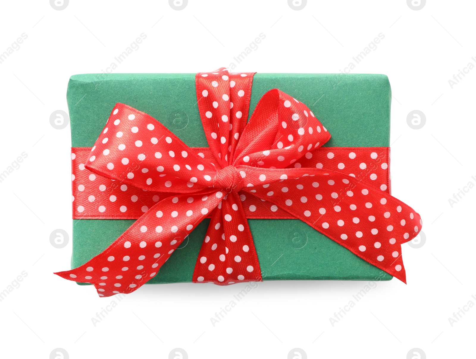 Photo of Christmas gift box decorated with red bow isolated on white, top view