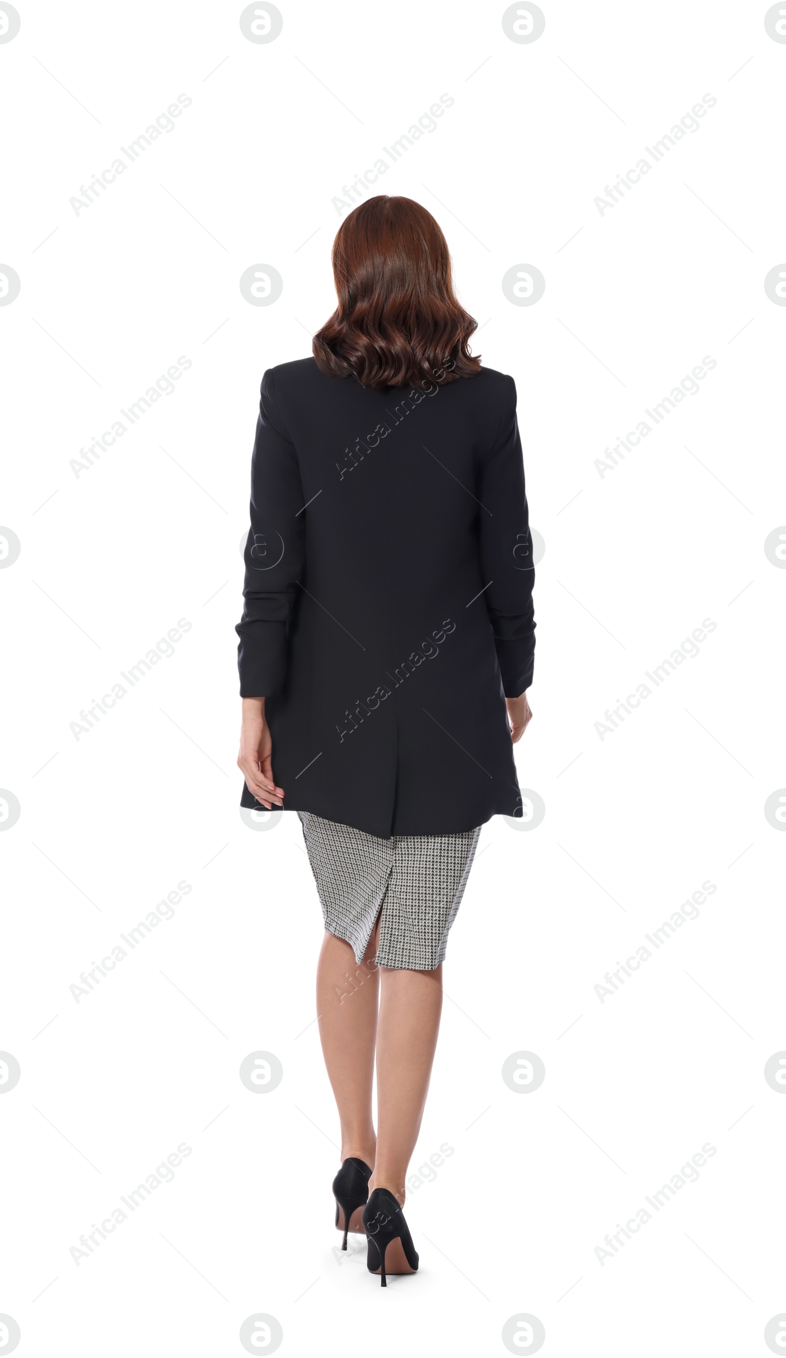 Photo of Woman in formal suit walking on white background, back view