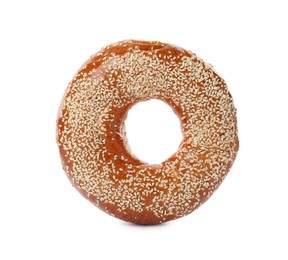 Photo of Delicious fresh bagel with sesame seeds isolated on white