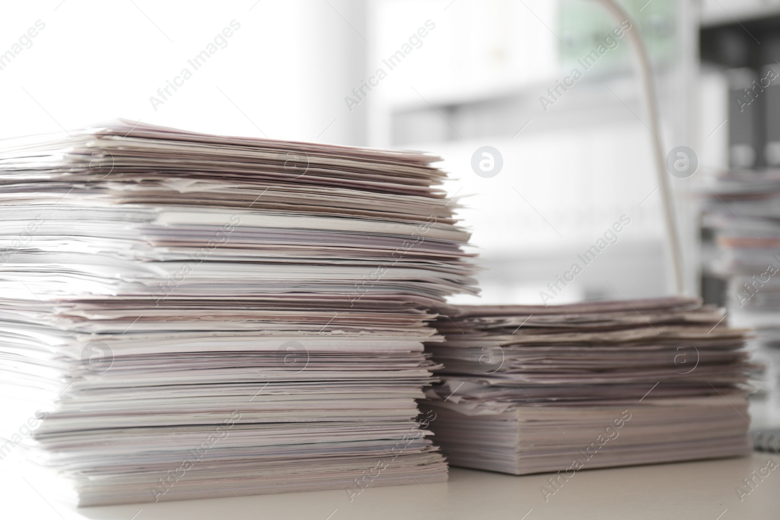 Photo of Stacks of documents on desk in office