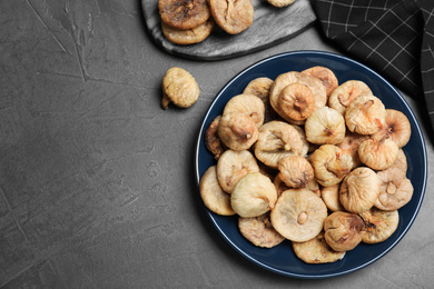 Tasty dried figs on grey table, flat lay. Space for text