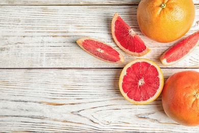 Photo of Flat lay composition with grapefruits and space for text on wooden background