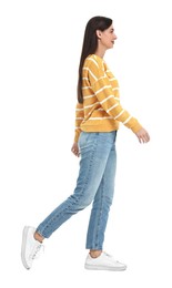 Photo of Young woman in jeans and sweater on white background