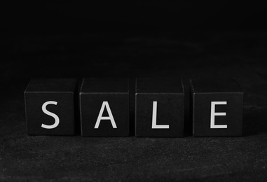 Photo of Cubes with word Sale on dark background, space for text. Black Friday concept