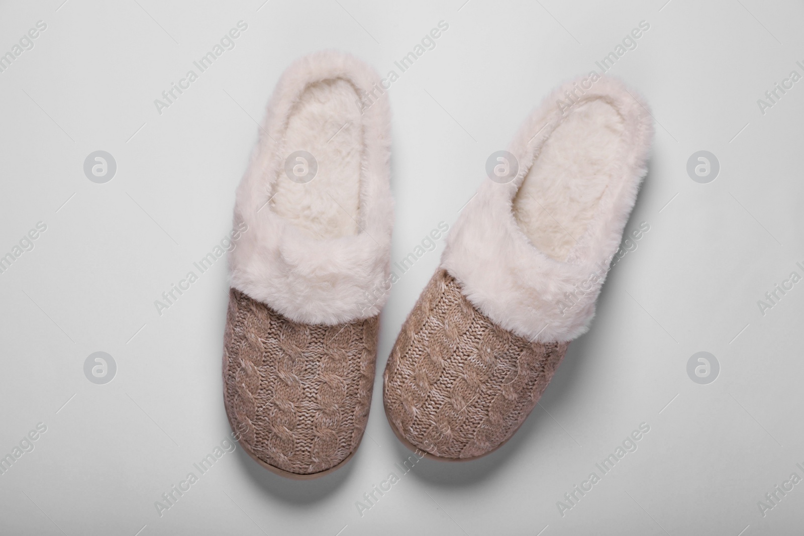 Photo of Pair of beautiful soft slippers on white background, top view