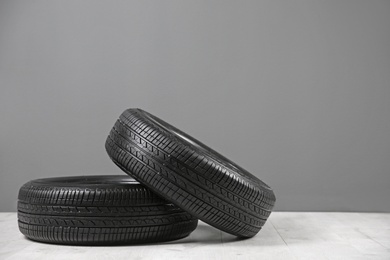 Photo of Car tires near gray wall