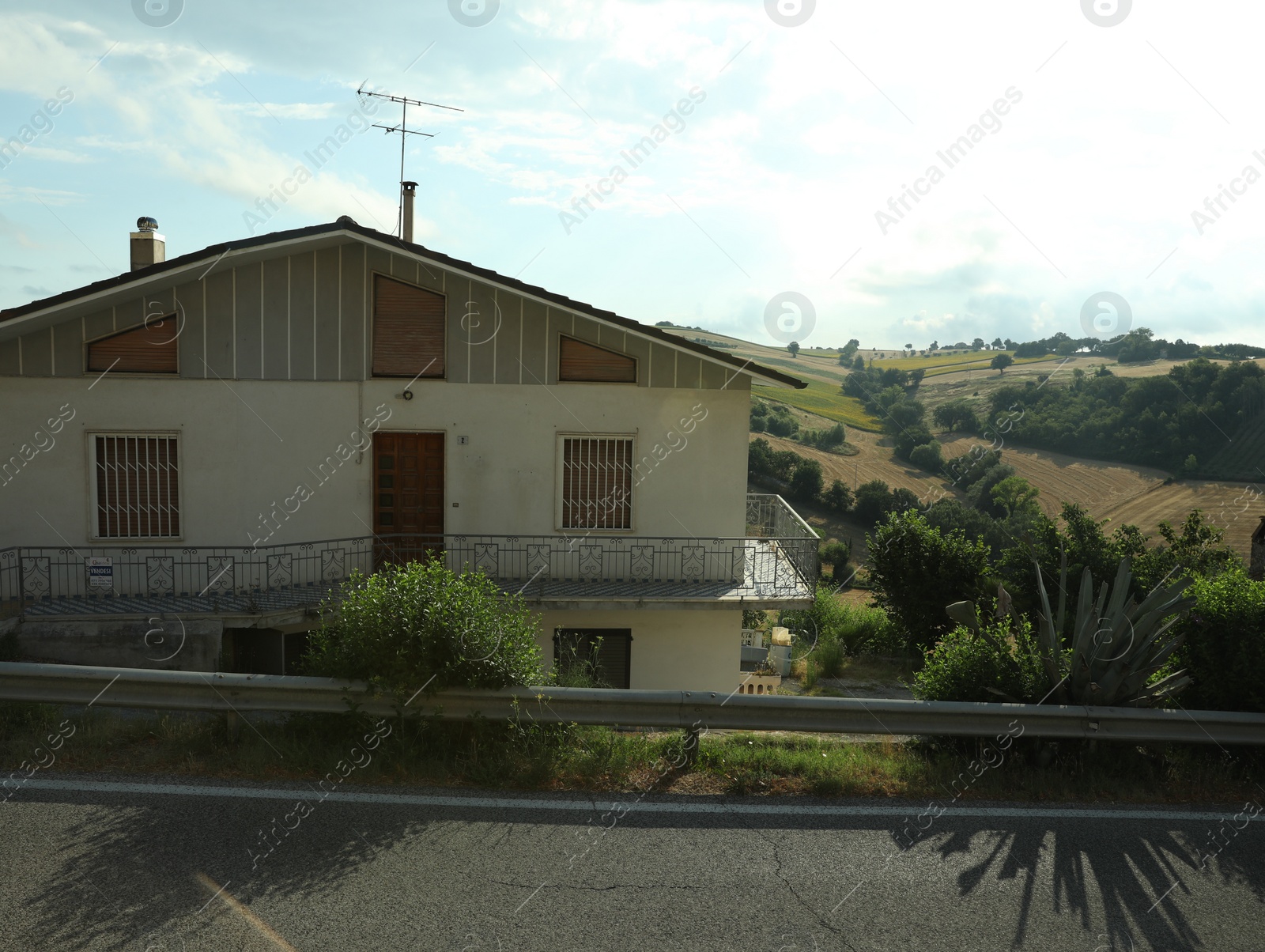 Photo of Big house with balcony and view of beautiful landscape on sunny day