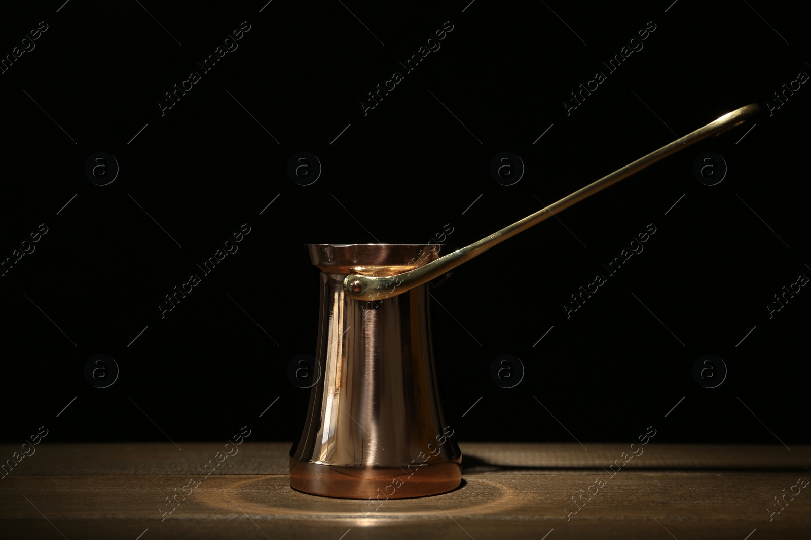 Photo of Beautiful copper turkish coffee pot on wooden table