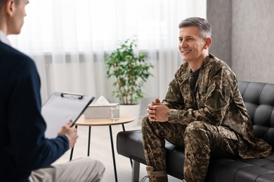 Photo of Professional psychotherapist working with military man in office