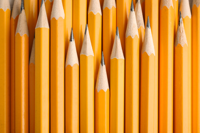 Photo of Many graphite pencils as background, top view