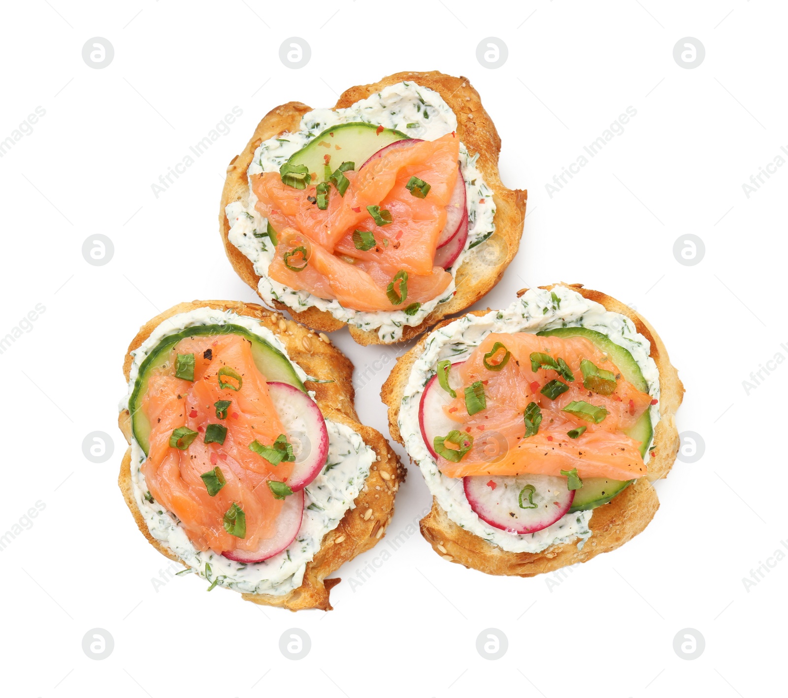 Photo of Tasty canapes with salmon, cucumber, radish and cream cheese isolated on white, top view