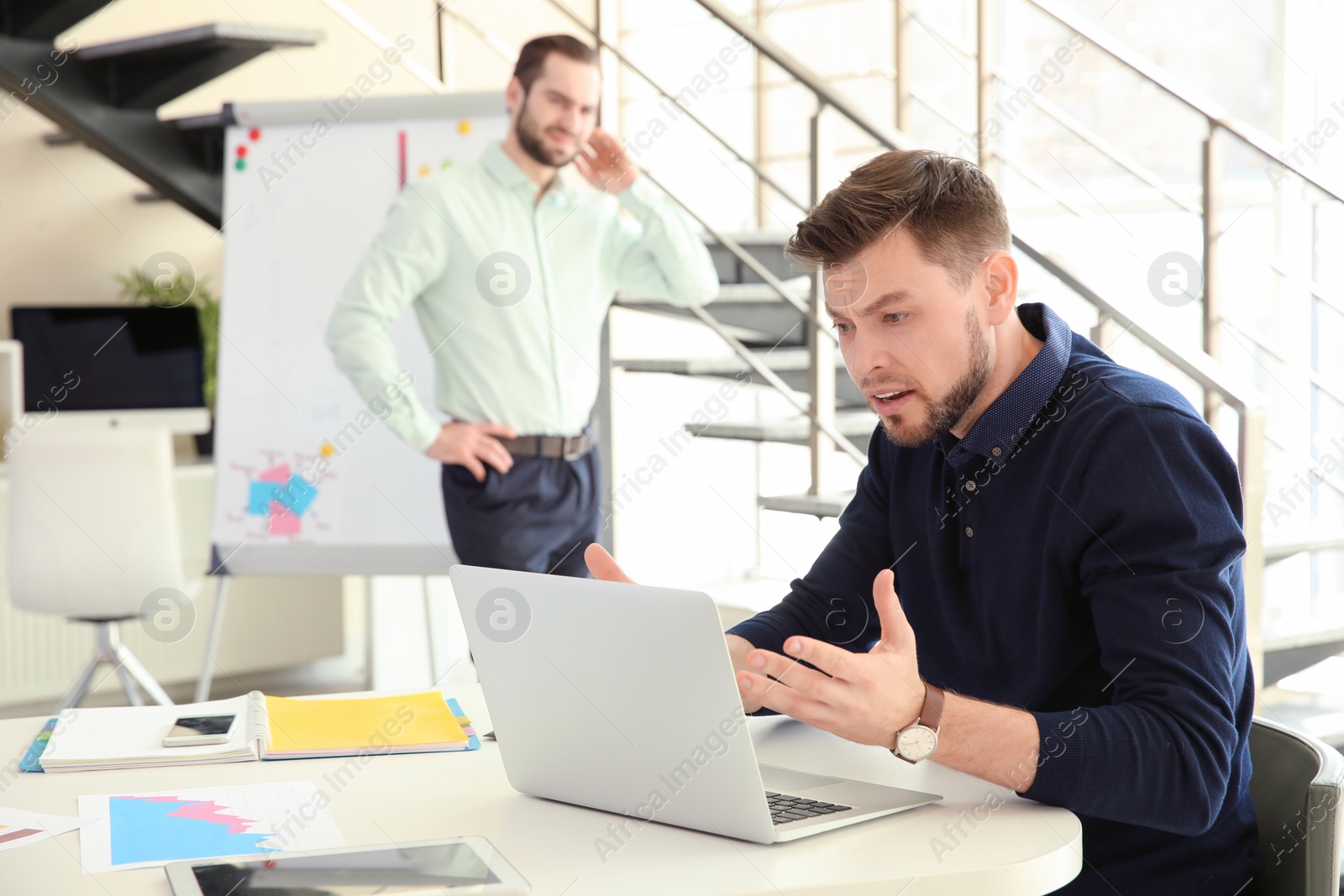 Photo of Office employees having argument at workplace