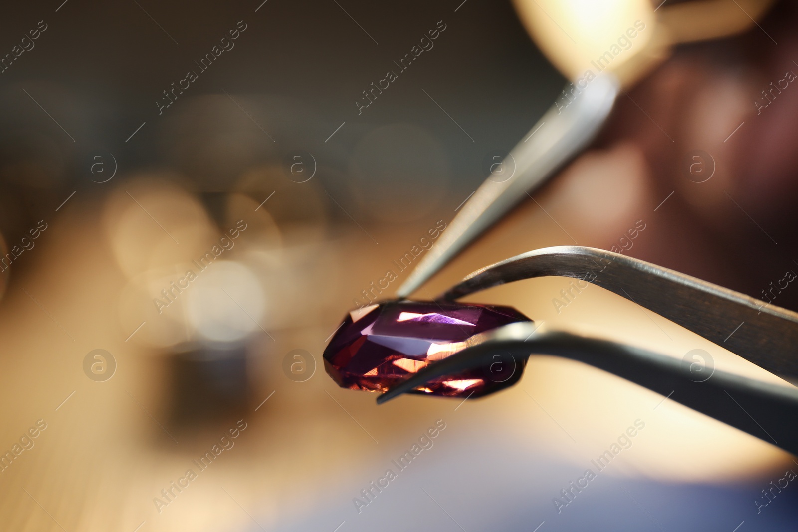 Photo of Beautiful gemstone in jeweler's workshop, closeup. Space for text