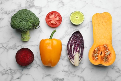 Photo of Flat lay composition with fresh ripe vegetables on marble background