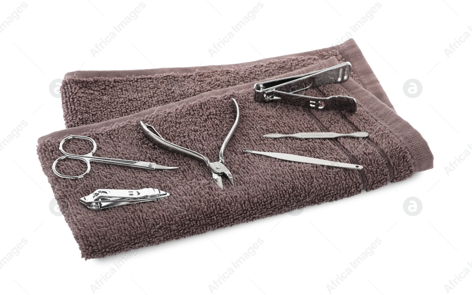 Photo of Manicure set on soft towel, white background