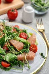 Photo of Delicious pomelo salad served on light grey table, closeup