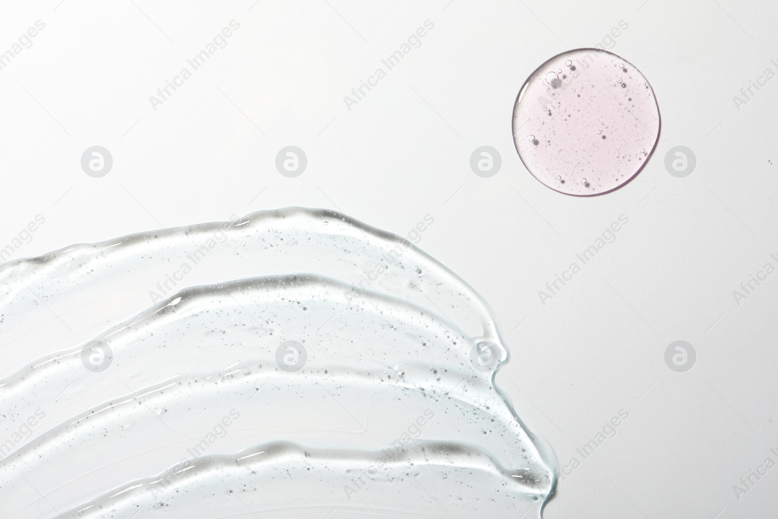 Photo of Samples of different cosmetic gels on white background, top view