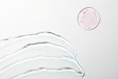 Photo of Samples of different cosmetic gels on white background, top view