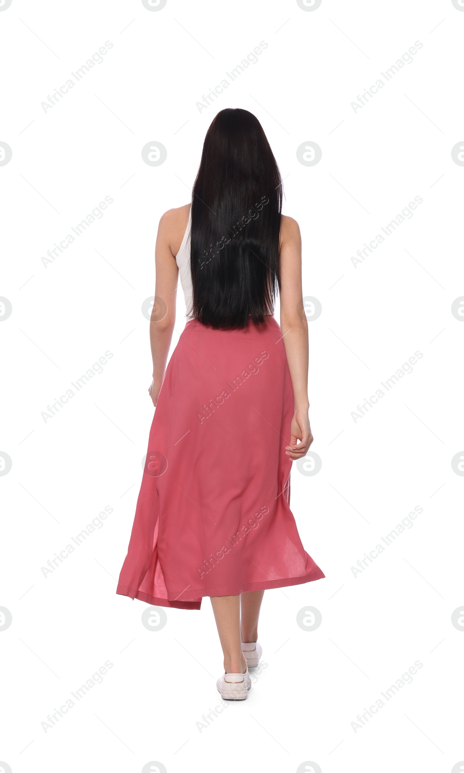 Photo of Woman in casual outfit walking on white background, back view