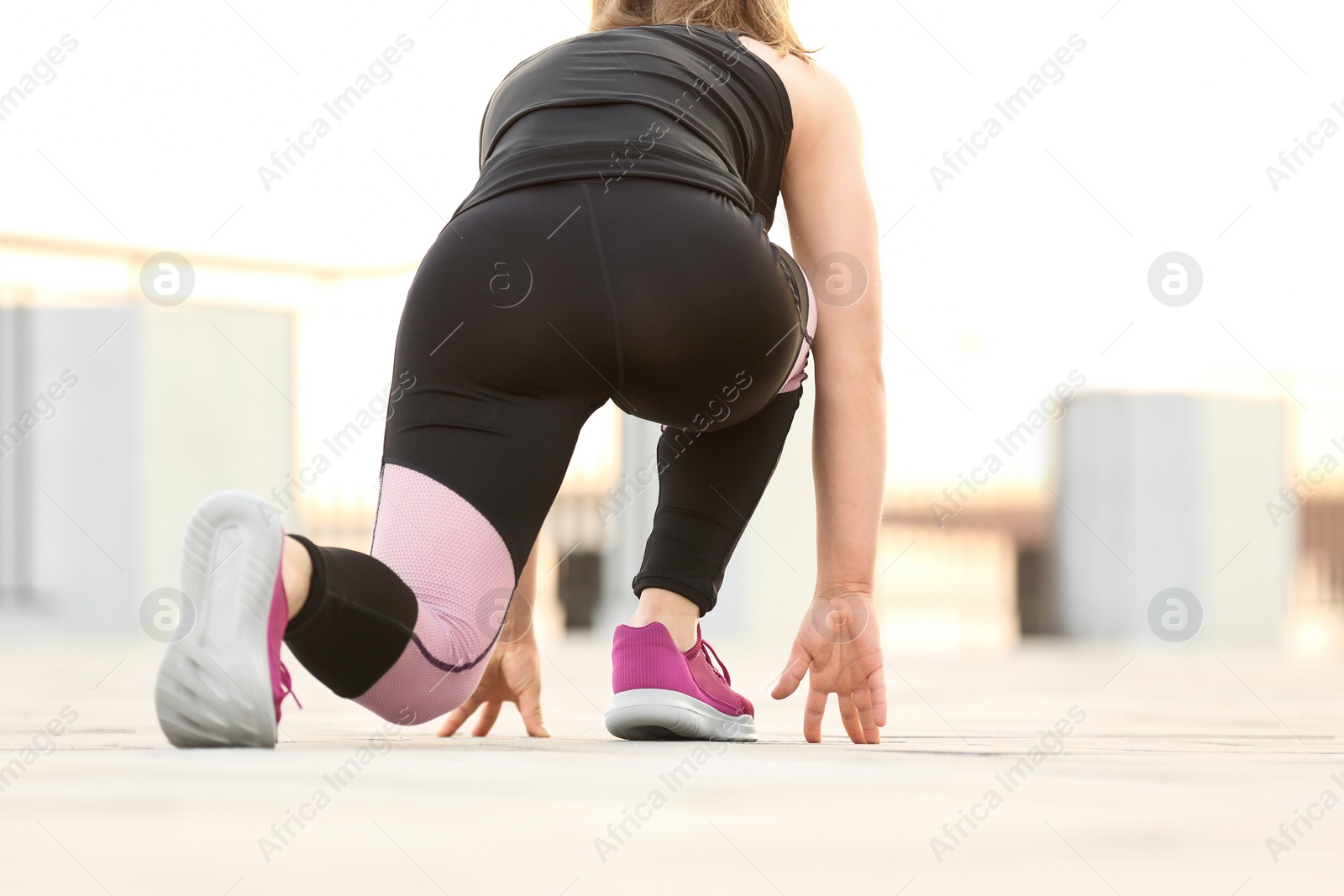 Photo of Young woman ready for running outdoors on sunny day