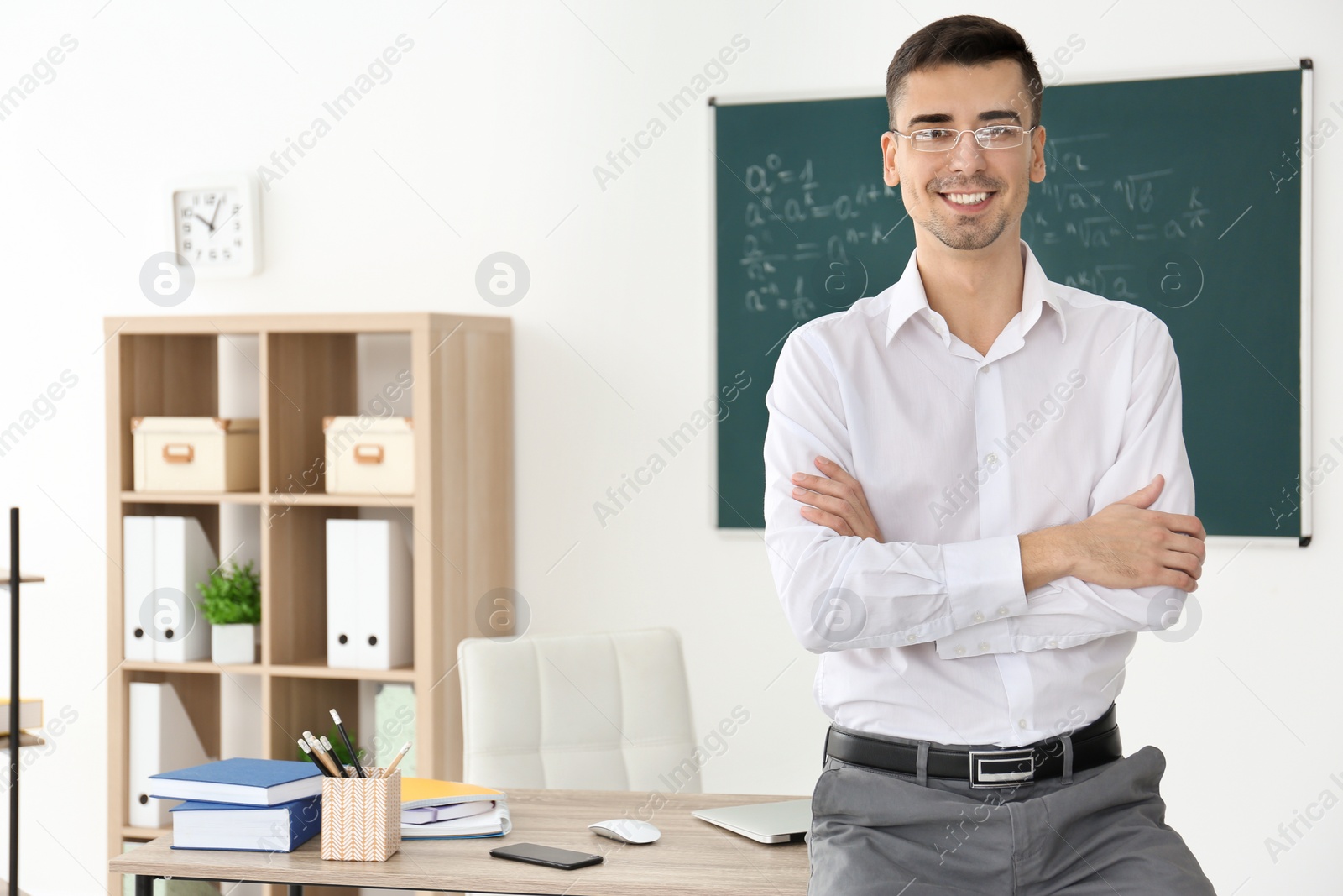 Photo of Young male teacher in classroom