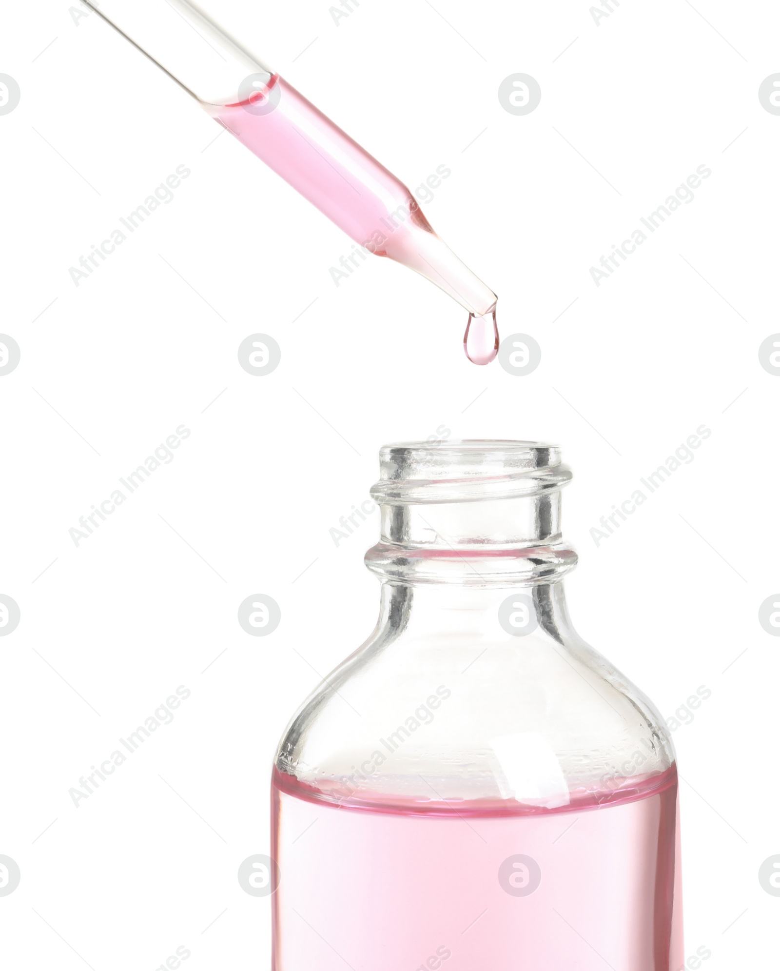 Photo of Dripping rose essential oil from pipette into bottle isolated on white