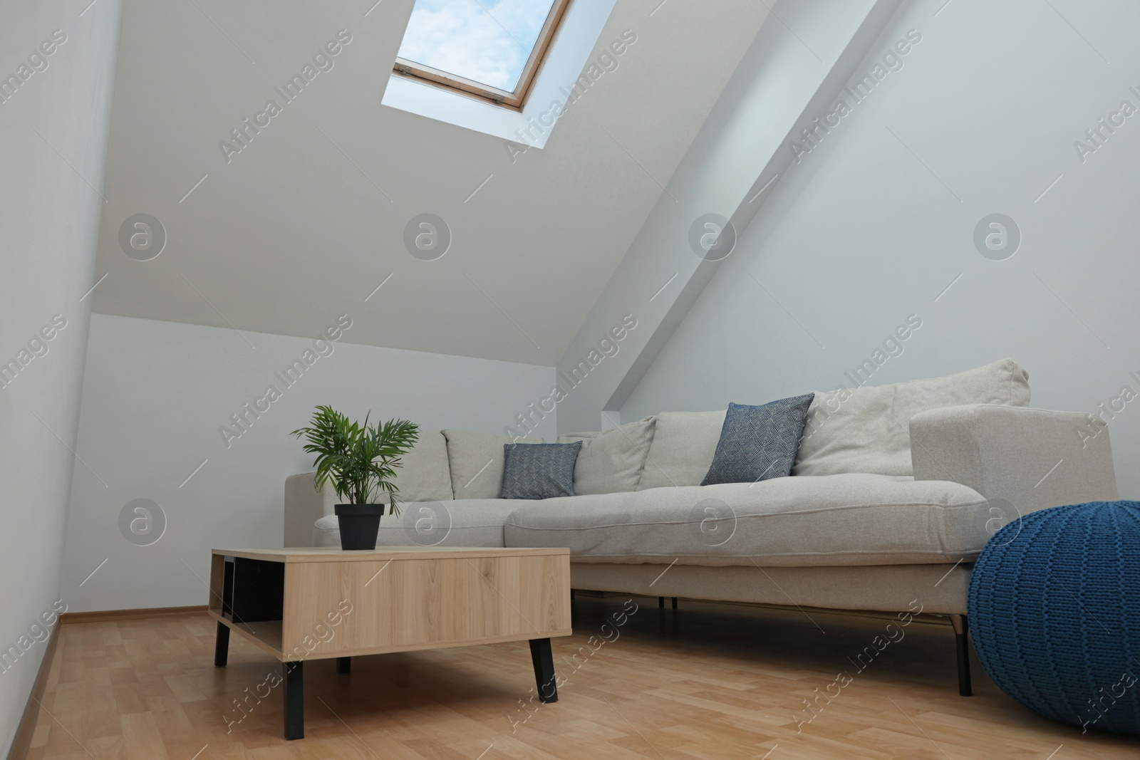 Photo of Attic room interior with slanted ceiling and furniture