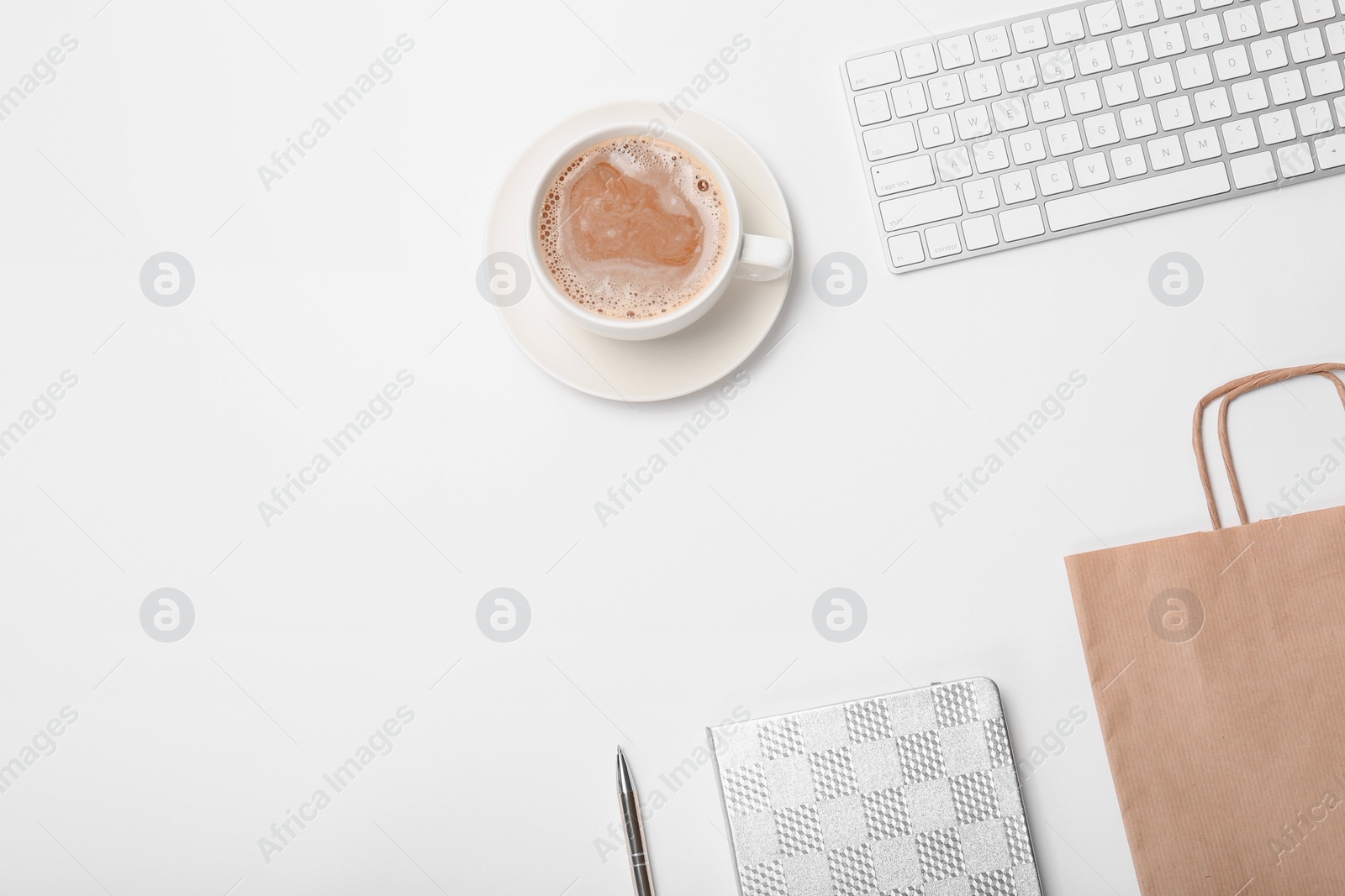 Photo of Stylish flat lay composition with shopping bag and cup of coffee on white background