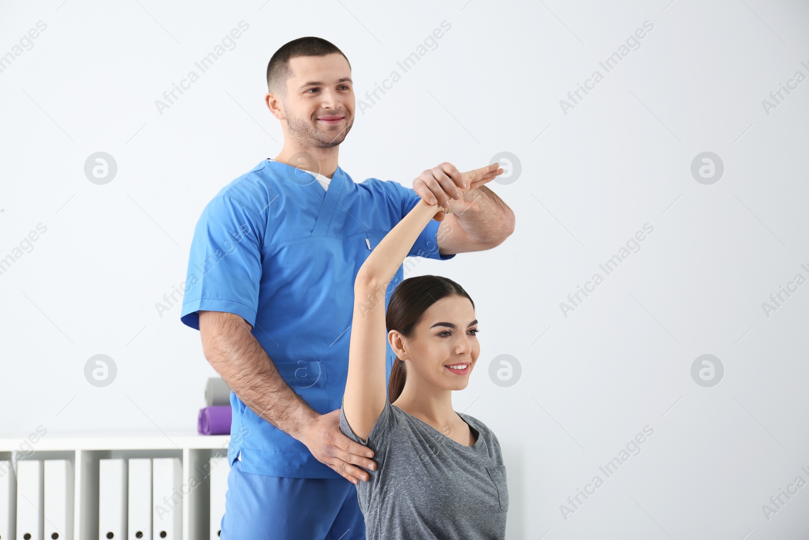 Photo of Doctor working with patient in hospital. Rehabilitation exercises