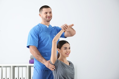 Doctor working with patient in hospital. Rehabilitation exercises