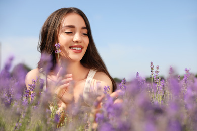 Photo of Young woman in lavender field on summer day