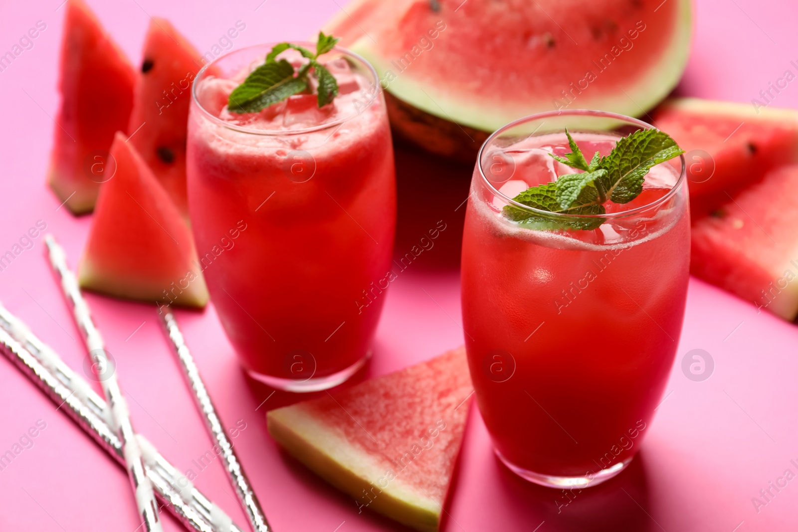 Photo of Tasty watermelon drink with mint on pink background, closeup