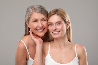 Photo of Beautiful women with healthy skin on gray background