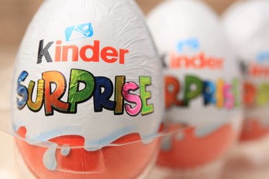 Photo of Slynchev Bryag, Bulgaria - May 25, 2023: Kinder Surprise Eggs on blurred background, closeup. Space for text