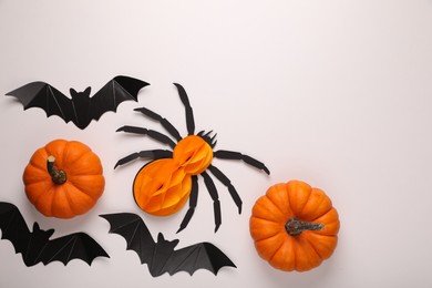Cardboard bats, pumpkins and spider on white background, flat lay with space for text. Halloween celebration