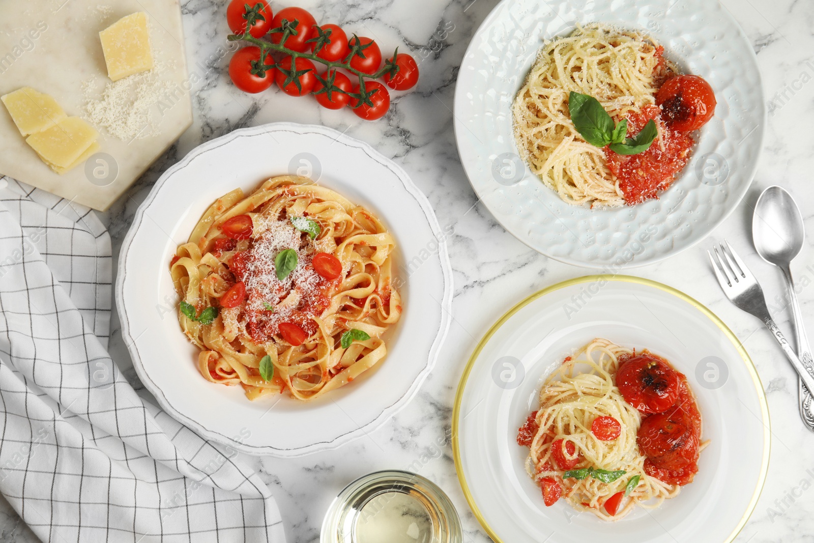 Photo of Flat lay composition with tasty pasta on white marble table