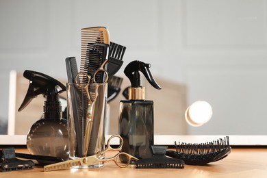 Set of hairdresser tools on table in salon, space for text