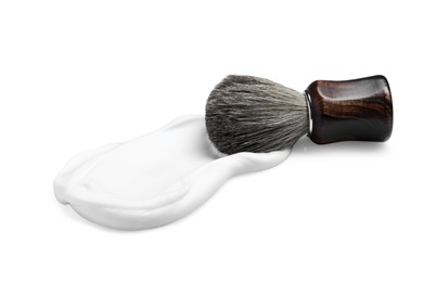 Photo of Shaving foam and brush on white background