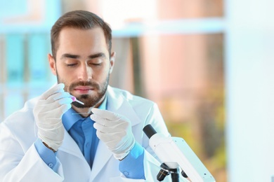 Photo of Young scientist working in laboratory, space for text. Chemical analysis