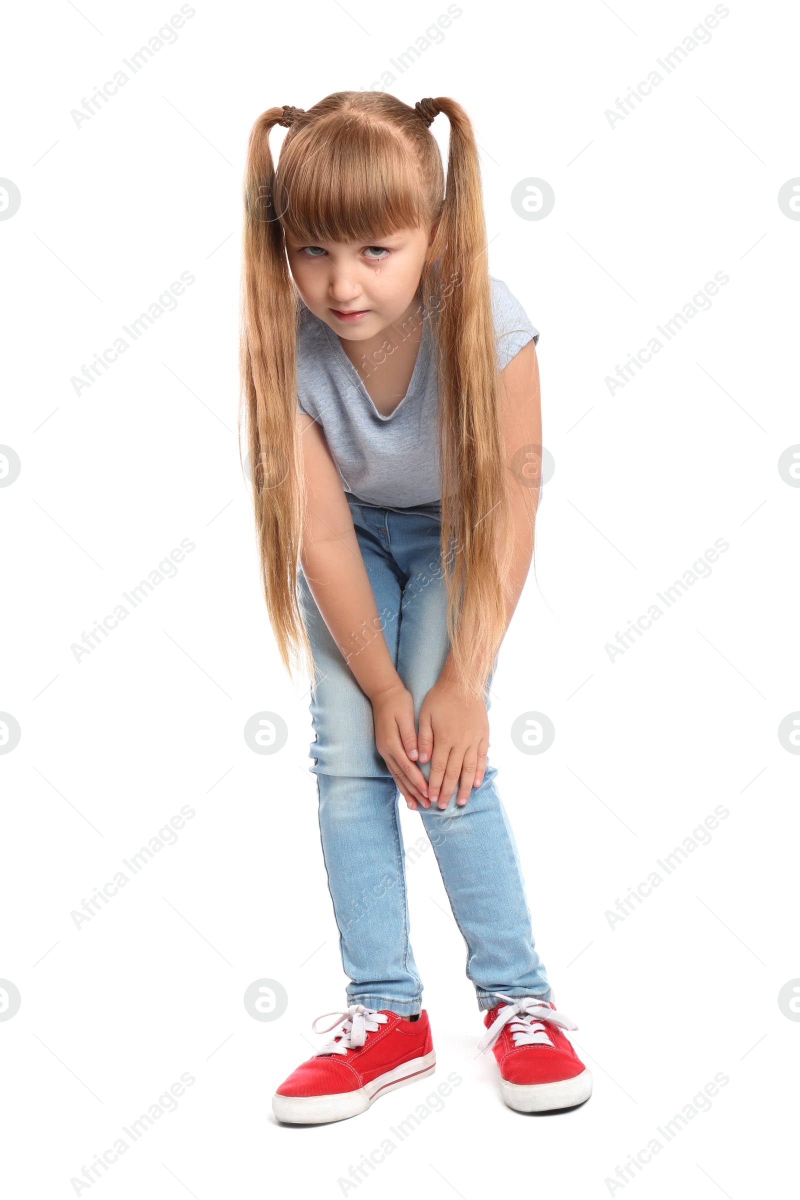 Photo of Full length portrait of little girl having knee problems on white background