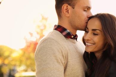 Photo of Happy couple in sunny park. Autumn walk