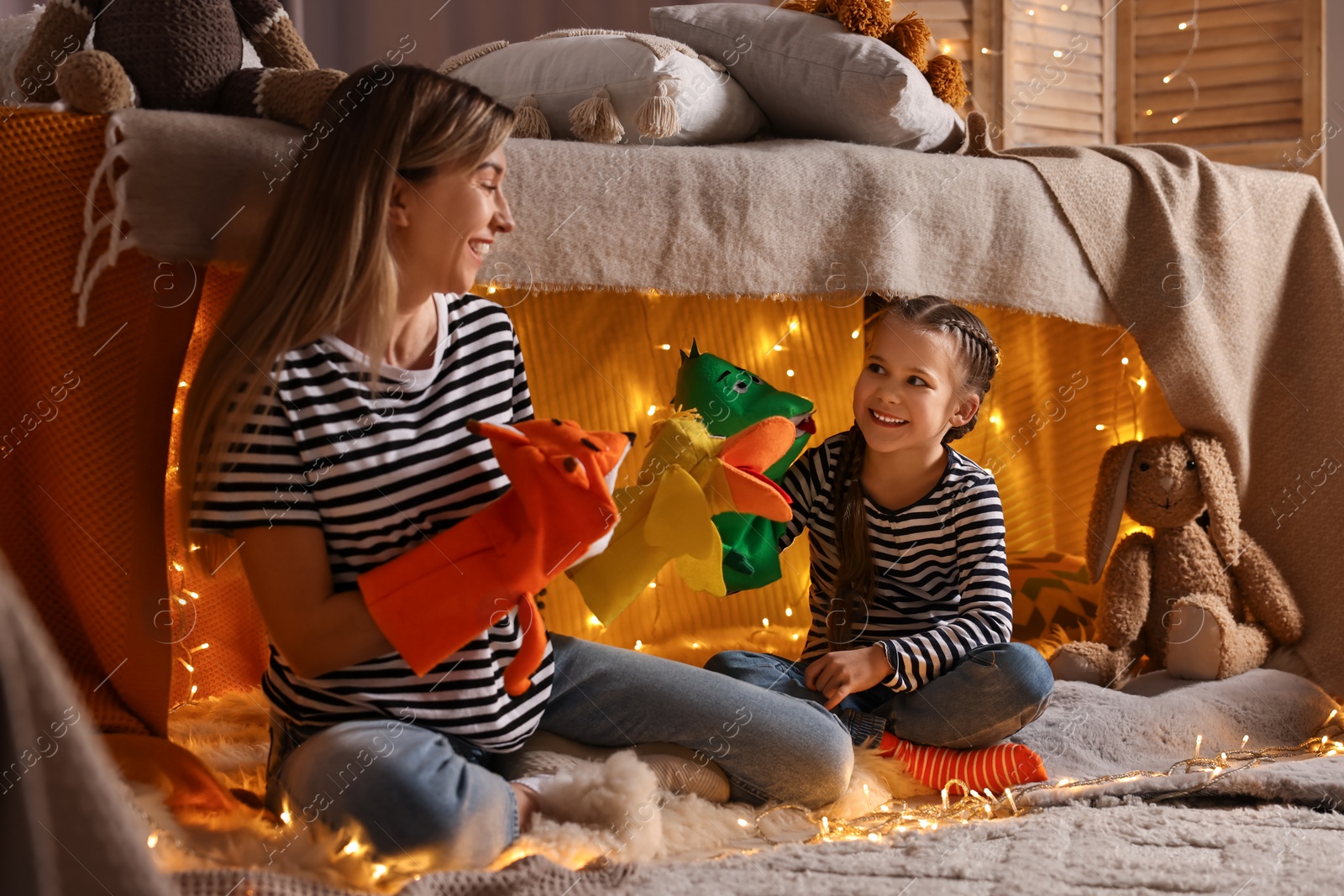 Photo of Mother and her daughter playing with toys in play tent at home