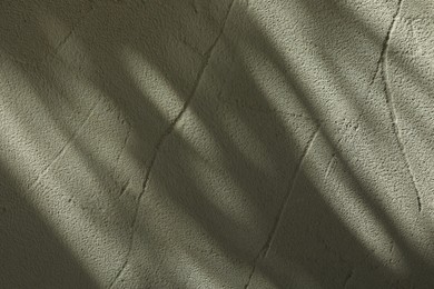 Light and shadows falling on textured wall