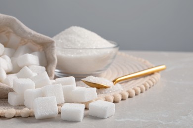 White sugar and wicker mat on light marble table, closeup. Space for text