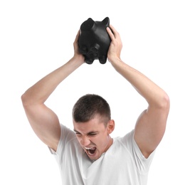Photo of Handsome young man breaking piggy bank on white background